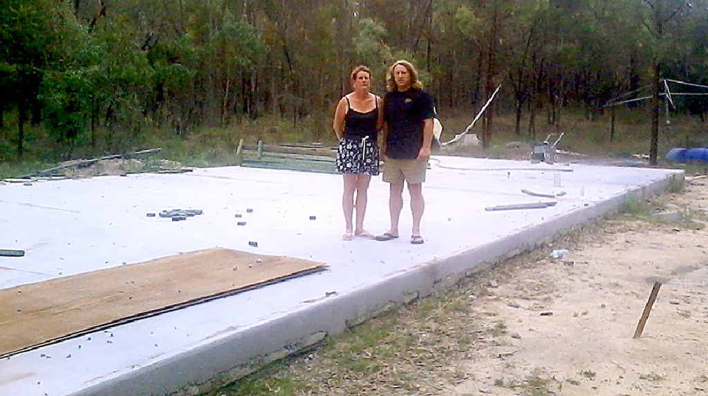 Tracy and Dennis Sinclair stand on the bare cement slab where their replacement home was beginning to take shape. Tracy and Dennis Sinclair stand on the bare cement slab where their replacement home was beginning to take shape.